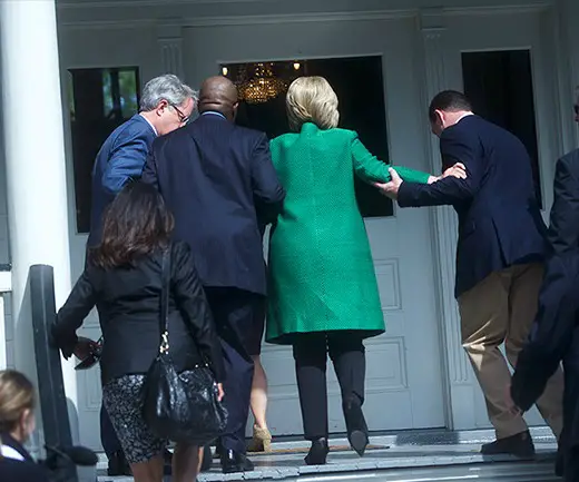 Hillary being helped up the stairs